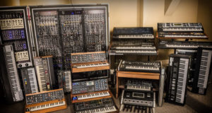 A room filled with syntronik synthesizers and keyboards.